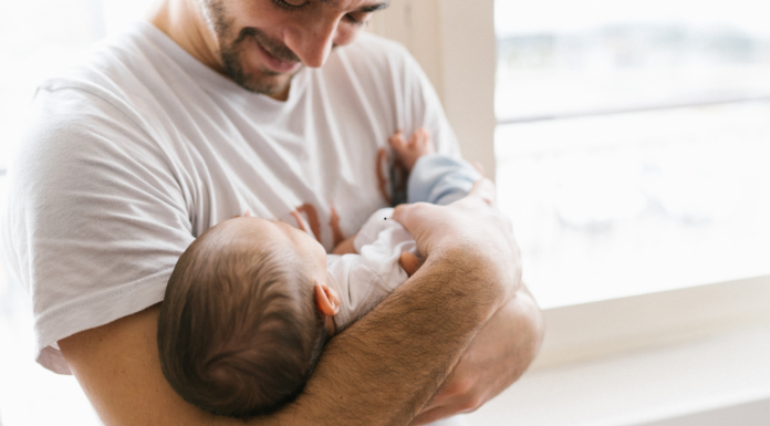 A dad holding his baby.
