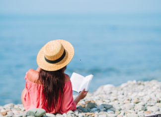 A woman reading at the beach.