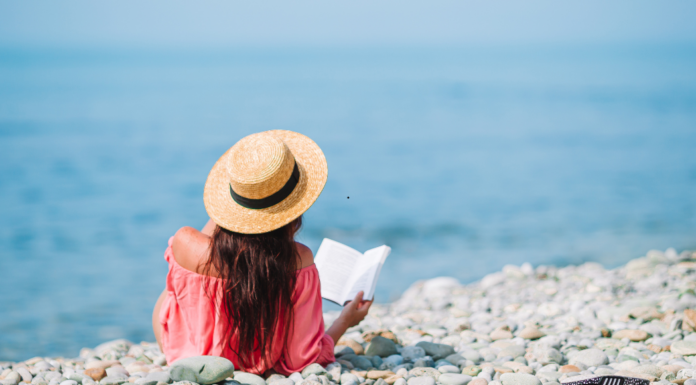 A woman reading at the beach.