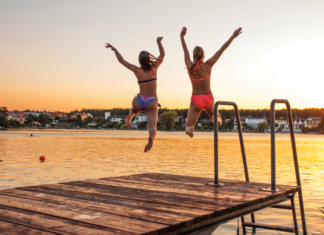 A Teacher Mom jumping off a dock.