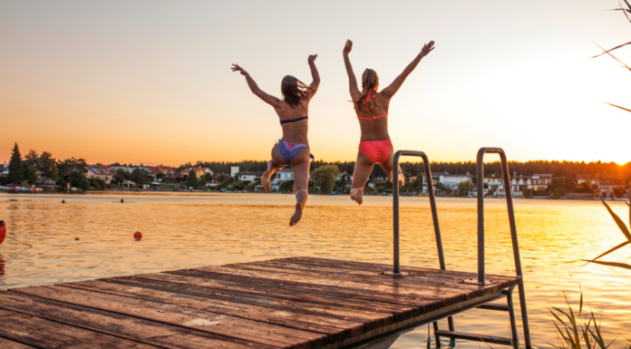 A Teacher Mom jumping off a dock.