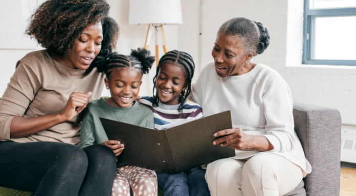 A family looking through a photo book.