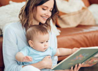 A mom showing a baby book to her baby.