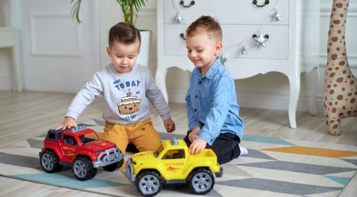 Boys playing with trucks.