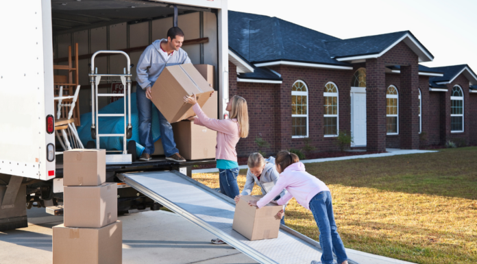 A family unpacking a moving van.