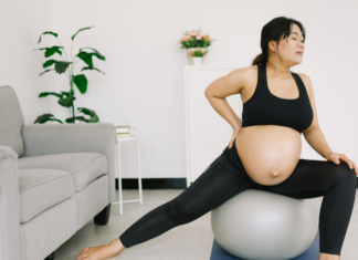 Top Five Yoga Poses for Expectant Mamas A pregnant woman doing yoga.