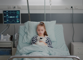 Sick child in a hospital bed.
