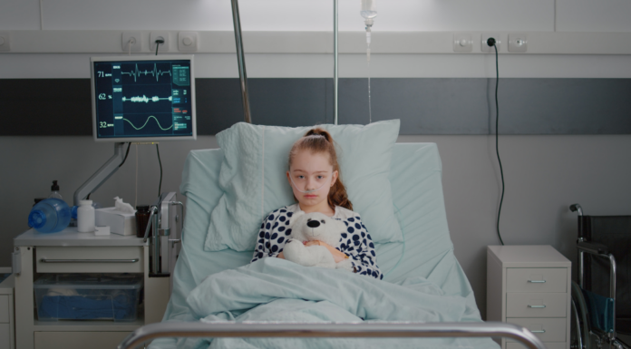 Sick child in a hospital bed.