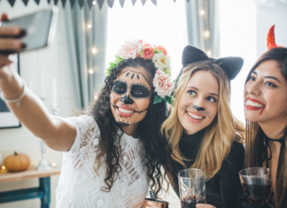 {Play Date Announcement} A Spooktacular Halloween Costume Party Women at a costume party taking a selfie.