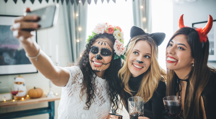 Women at a costume party taking a selfie.