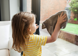 A toddler doing chores to earn money.