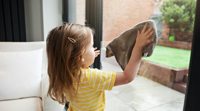 A toddler doing chores to earn money.