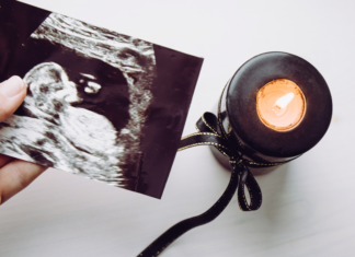 Holding a sonogram photo after a loss.
