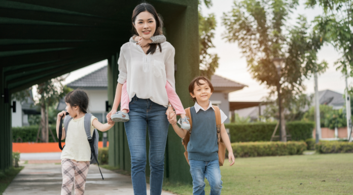 A mom walking home from school with her three kids.