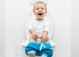 A boy sitting on a potty.