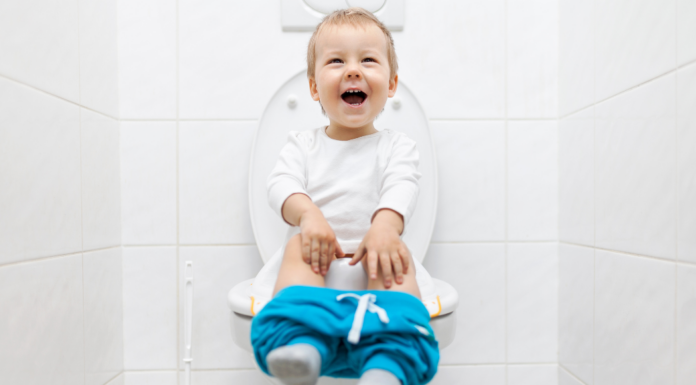 A boy sitting on a potty.