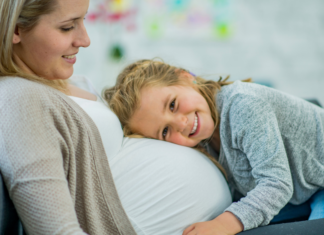 Dear Daughter {Before You Become A Big Sister} A daughter hugging and holding her mom's pregnant belly.