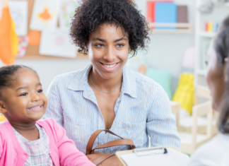 A mom and daughter meeting with a teacher.