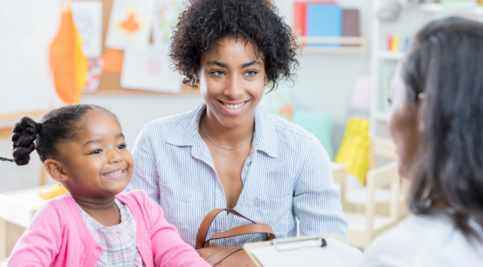 A mom and daughter meeting with a teacher.