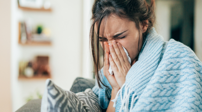A sick mom blowing her nose.