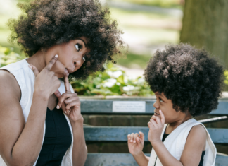 Mom interviewing her son on a park bench.