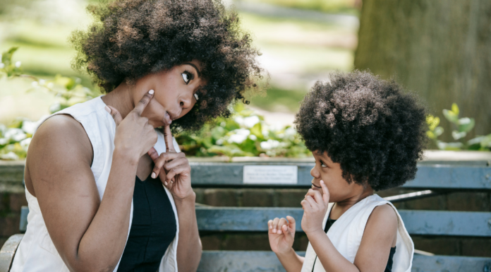 Mom interviewing her son on a park bench.