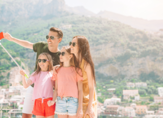 A family on vacation taking a selfie.