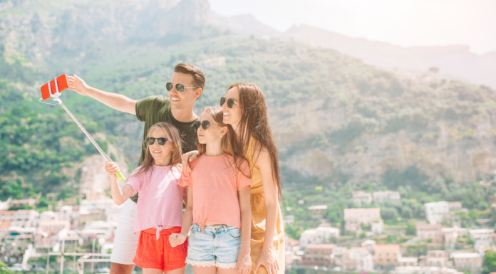 A family on vacation taking a selfie.