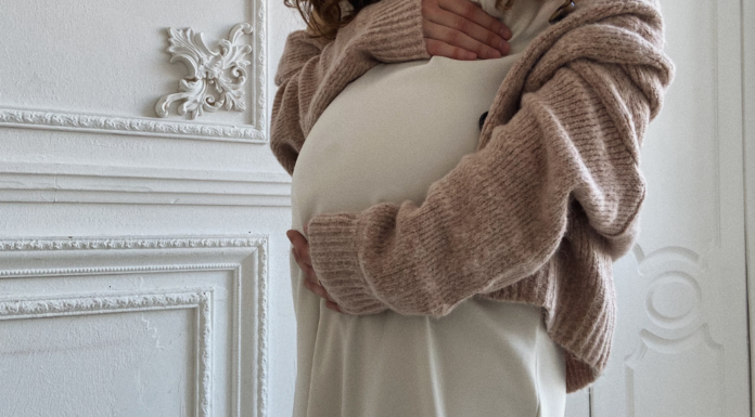 A pregnant woman holding her belly.