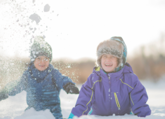 Boys playing outside in the snow.