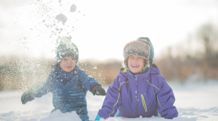 Boys playing outside in the snow.