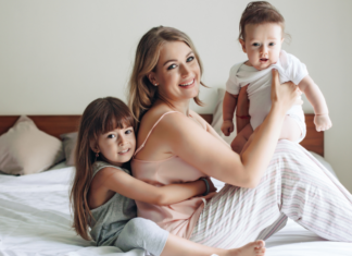 From One Tired Mama to Another A tired mom holding her kids.