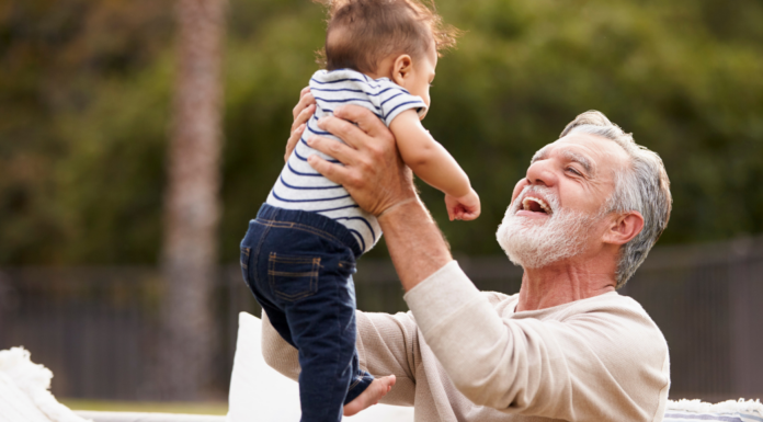 A grandpa holding his baby grandchild.