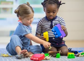 Let’s Have Fun with Leap Year! Two children playing together with blocks.