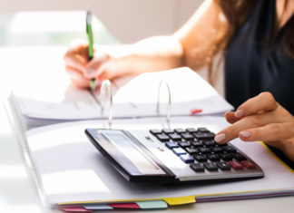 Someone using a calculator when filing taxes.