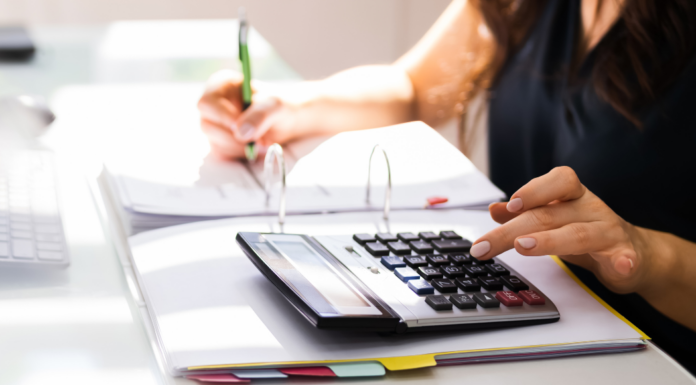 Someone using a calculator when filing taxes.