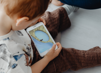 A toddler on a phone.