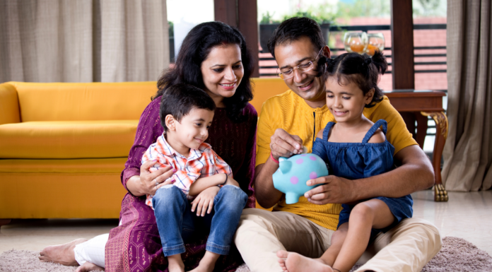 A family putting money in a piggy bank.