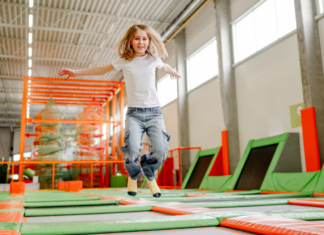 Exercise & Fun at The Ultimate Trampoline Park A kid bouncing at a trampoline park.