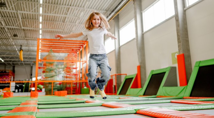 A kid bouncing at a trampoline park.