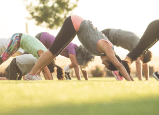 Women doing yoga in a backyard.