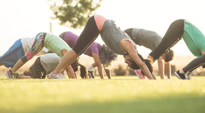 Women doing yoga in a backyard.
