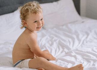 A toddler sleeping in a big boy bed.