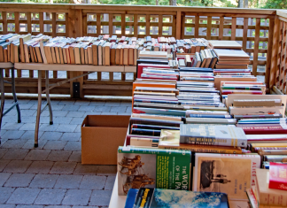Books lined up on tables at a book sale.