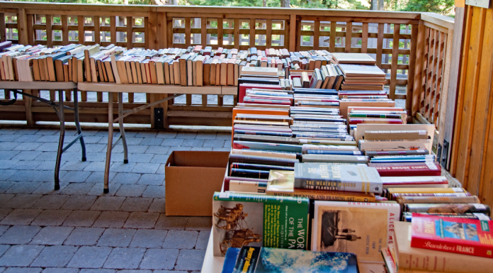 Books lined up on tables at a book sale.
