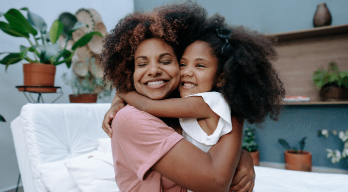 A mother and daughter hugging.