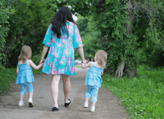 A mom walking with twins.