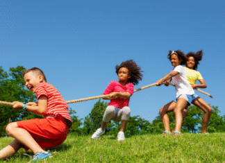 School’s Out For Summer Kids play tug of war.