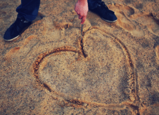 A heart drawn in the sand.