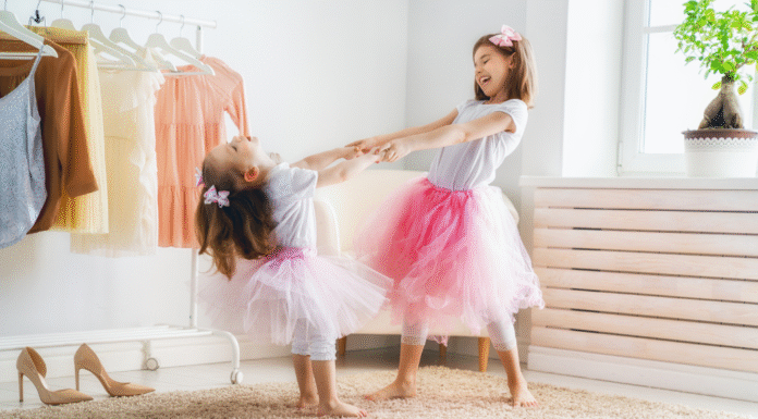 Two girls dressing up as princesses.